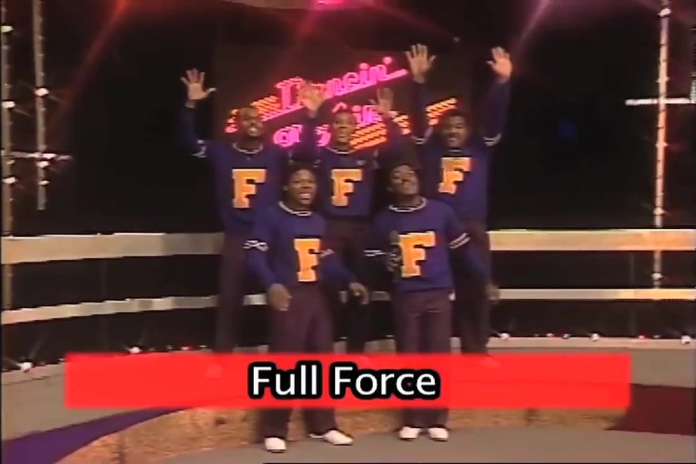 Full Force performing under the Dancin' On Air neon sign